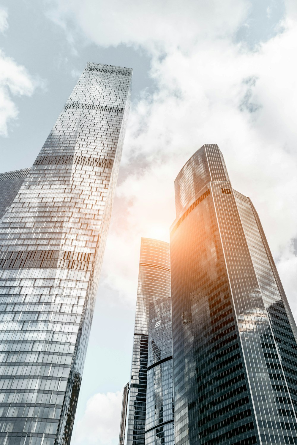 worm view photo of buildings under cloudy sky during daytime