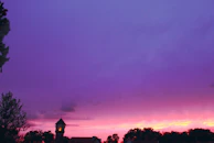 A peaceful sunset with purple and yellow hues, symbolizing new beginnings and connection beyond walls.