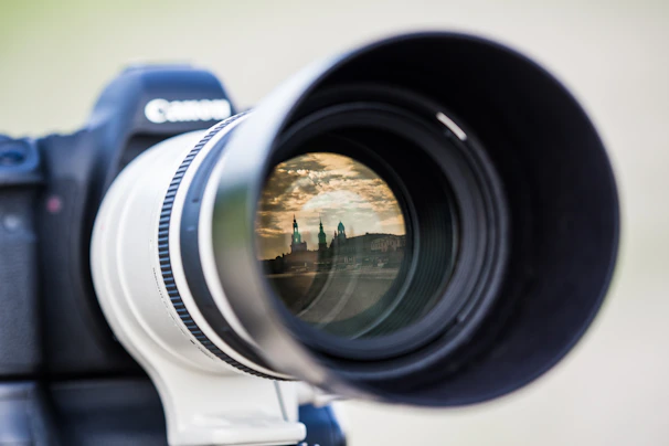 Close-up of a professional camera lens capturing a dynamic urban scene for a client project.