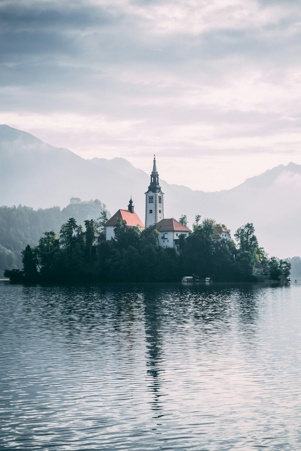 white concrete house beside body of water