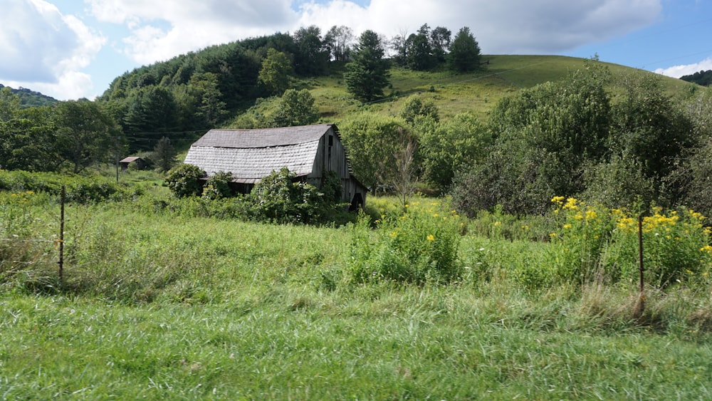 gray barn on grassland