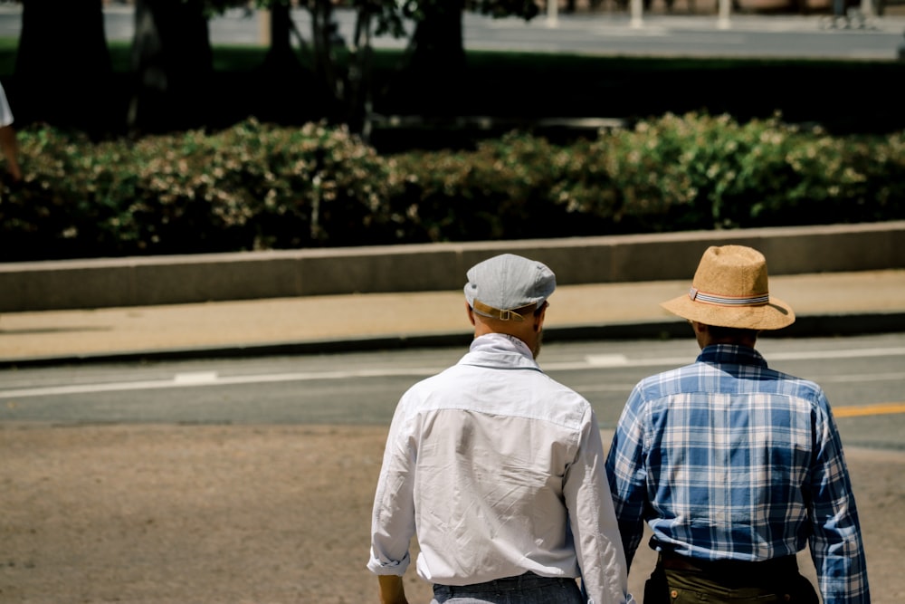 two men wearing cap and hat