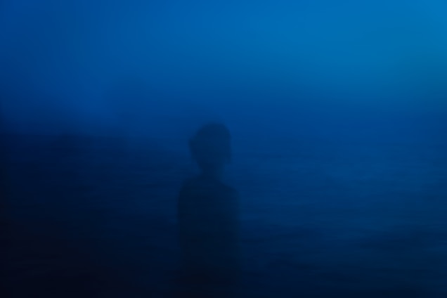 A silhouette of Jayson R. Valencian cloaked in mist, framed by faint claw marks and ghostly jungle shadows.