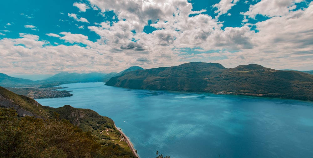 body of water and mountains during day