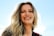 A smiling woman enjoying a sunny day outdoors, showcasing her healthy skin and vibrant energy.