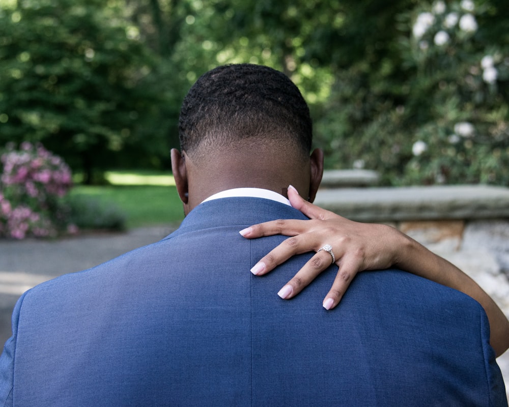 man wearing blue formal suit showing back