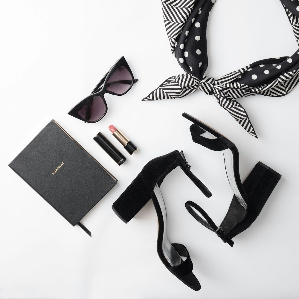 lipstick beside sunglasses and sandals