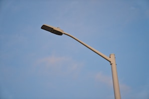 A close-up of a sleek, modern lamppost design prototype on a workbench.