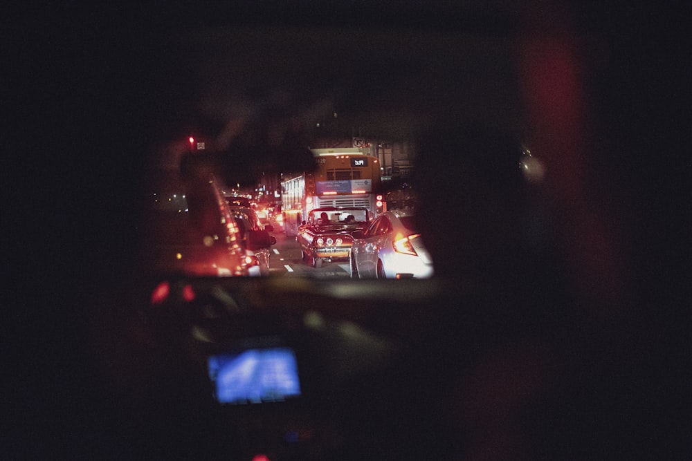 a view of a city at night from inside a vehicle