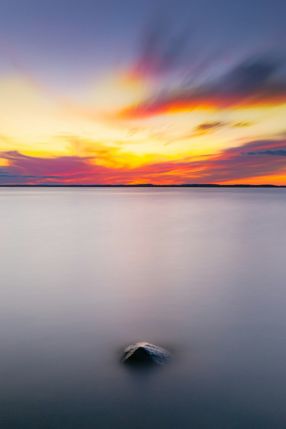 a rock in the middle of a body of water