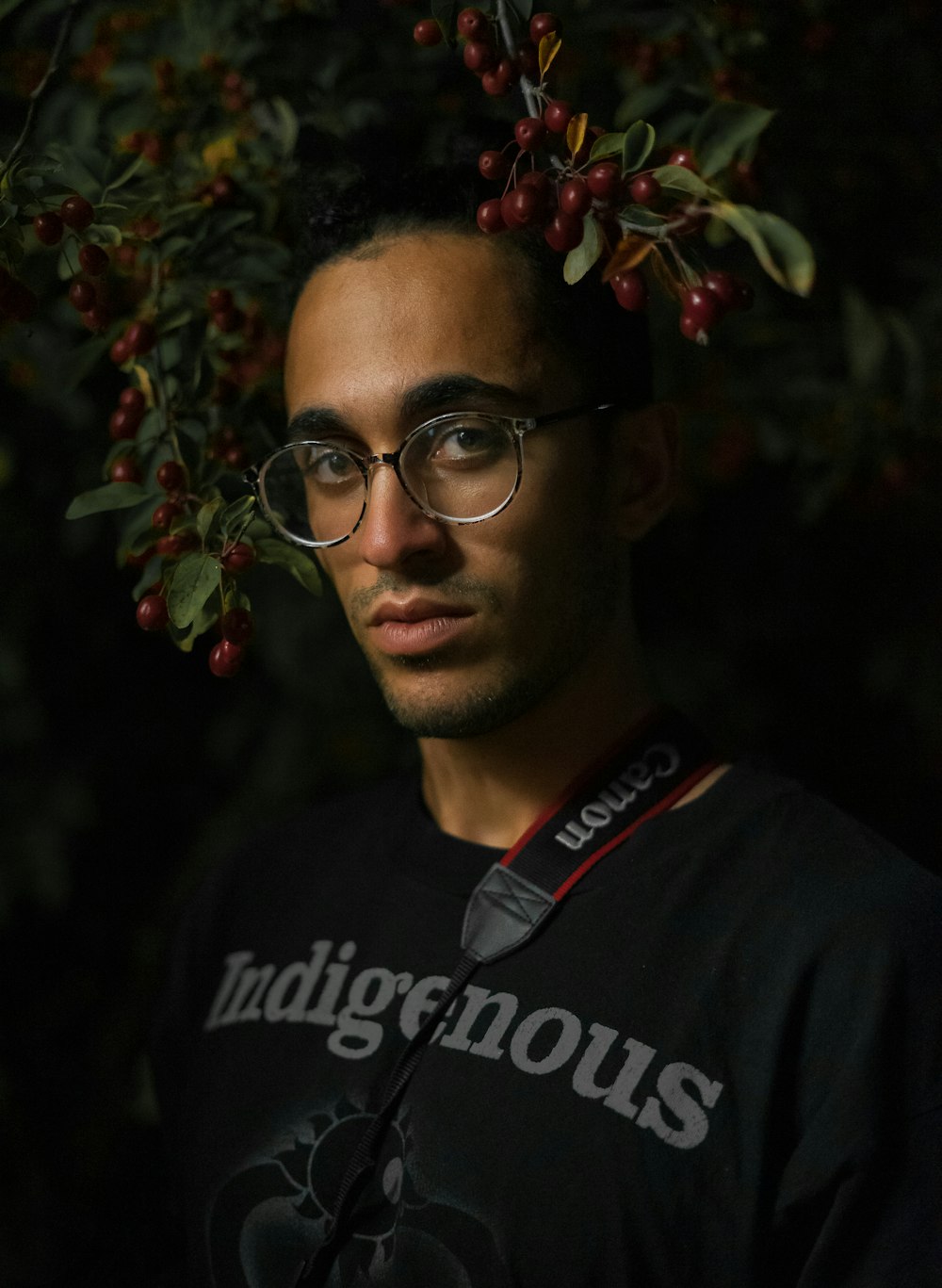 man wearing black shirt with Indigenous-text