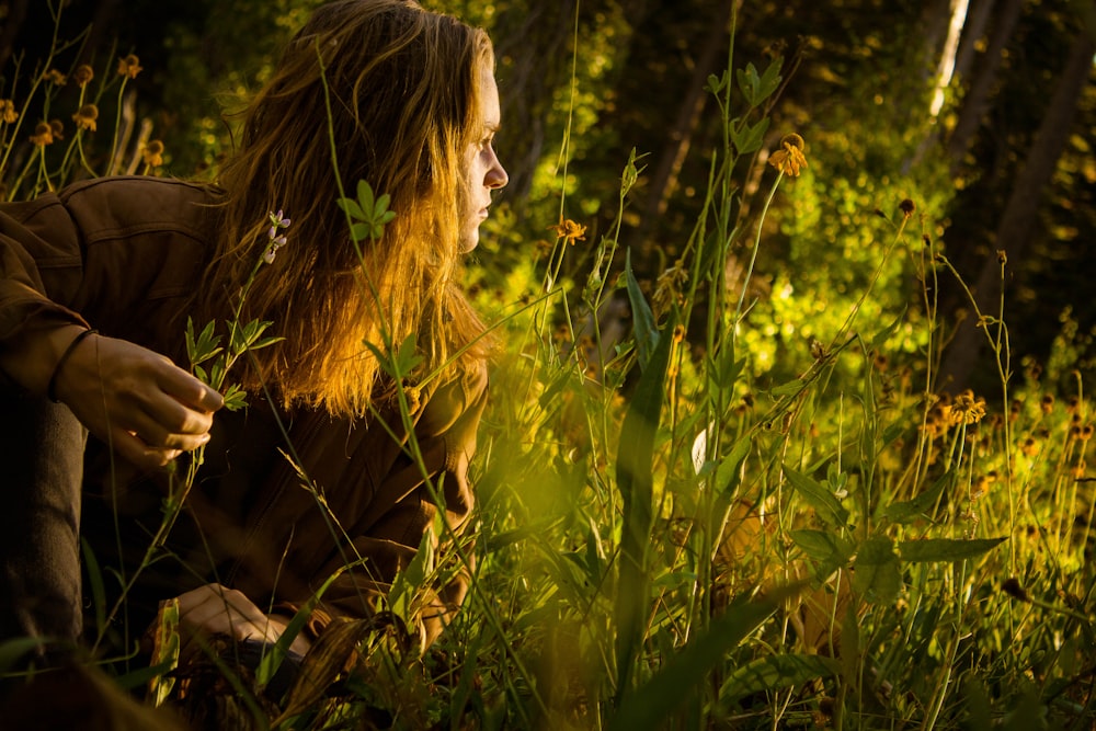 man sitting in grass field