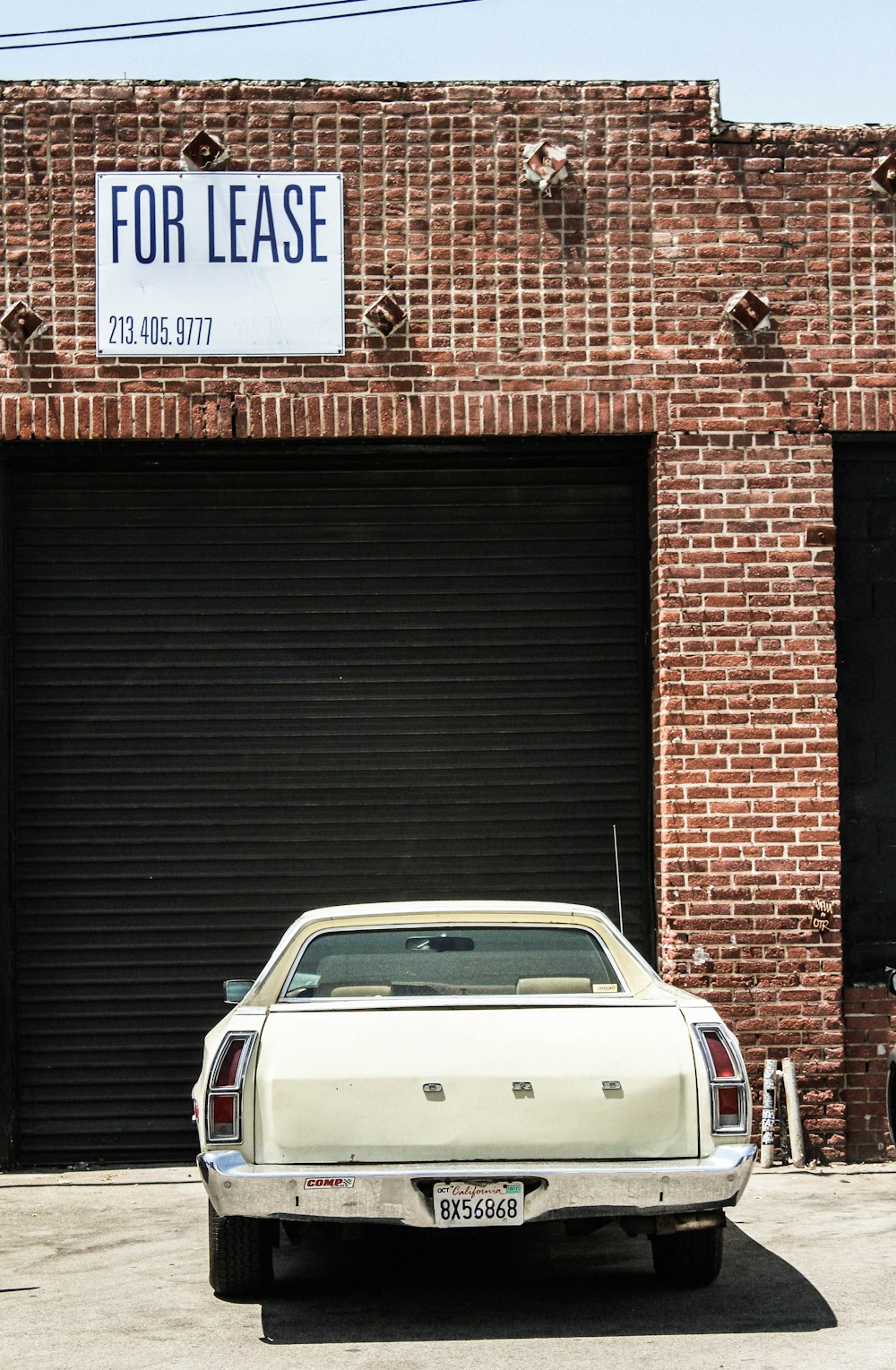 white classic car parked on parking space during daytime