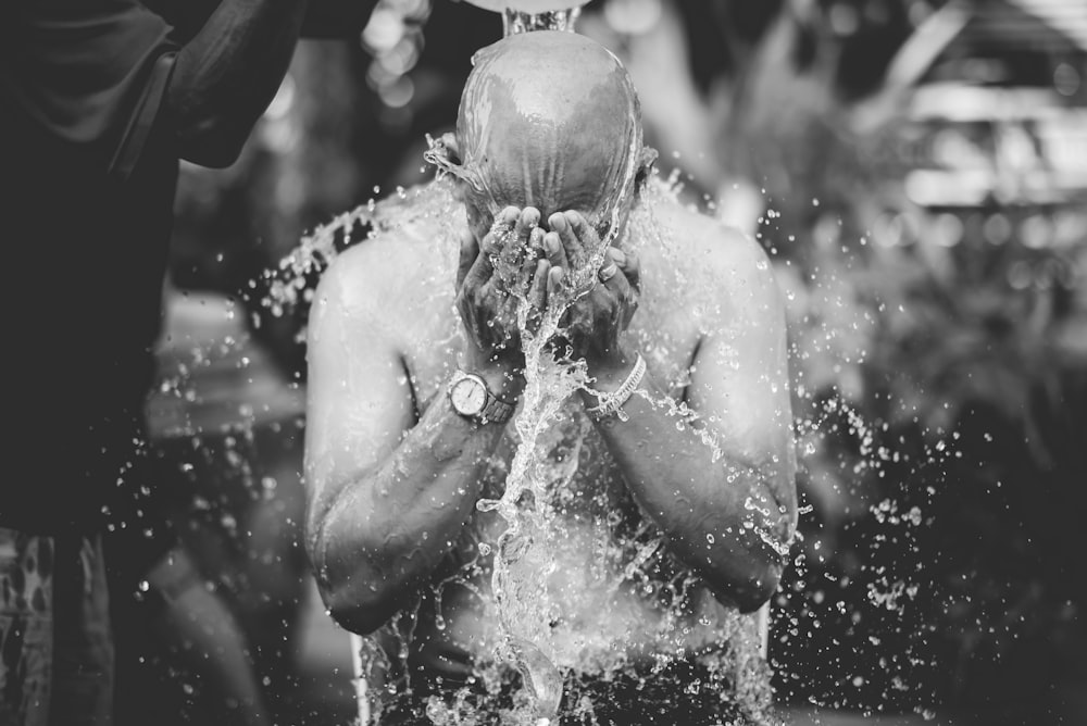 person pouring water on own face