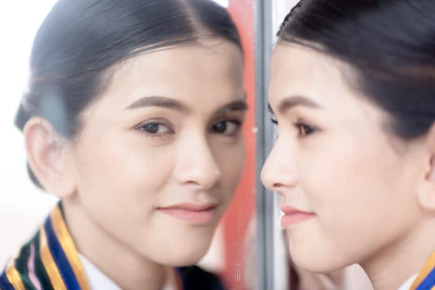 An Indian woman happily measuring her waist at home, reflecting progress in her weight loss journey.