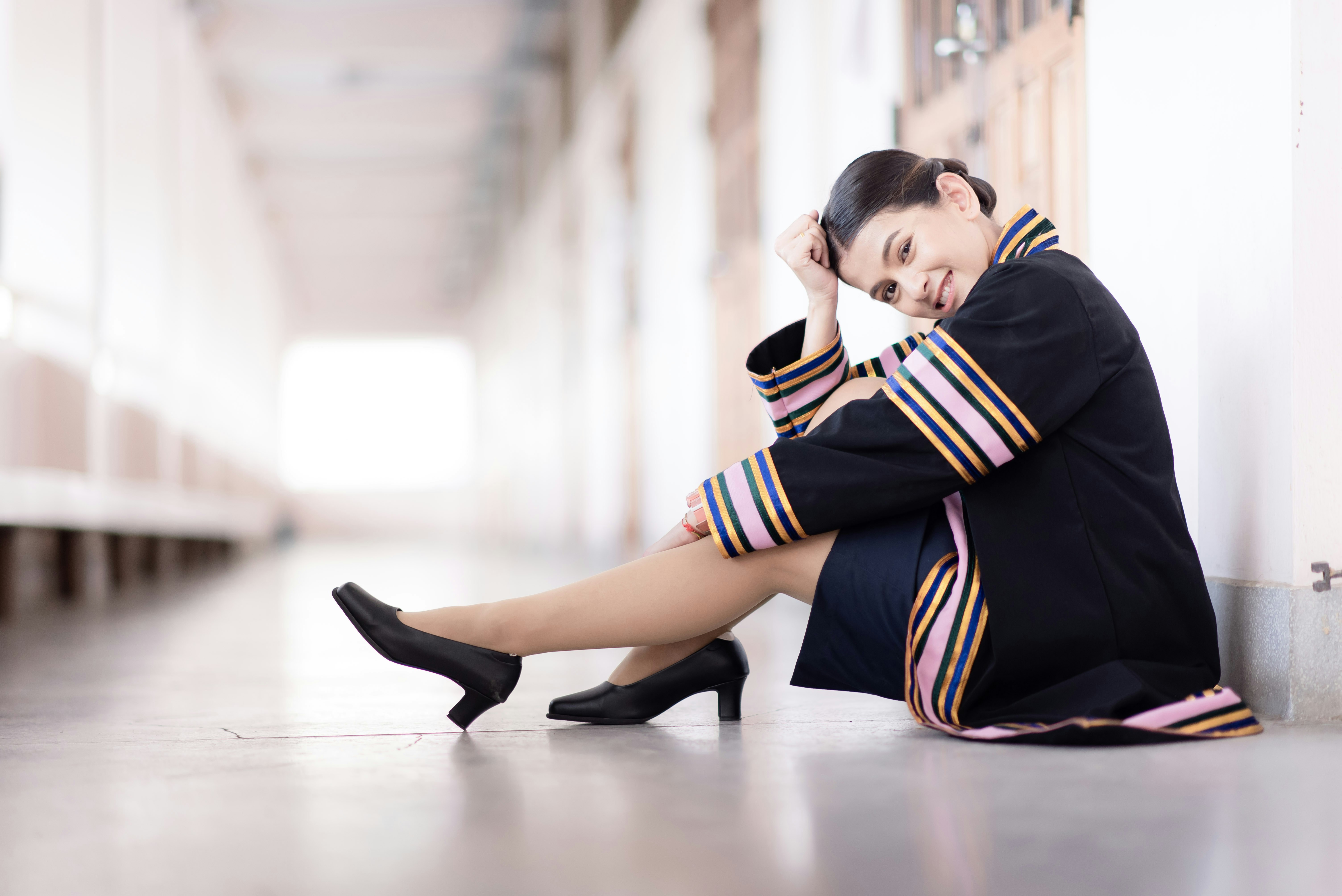 woman in black coat sitting on floor
