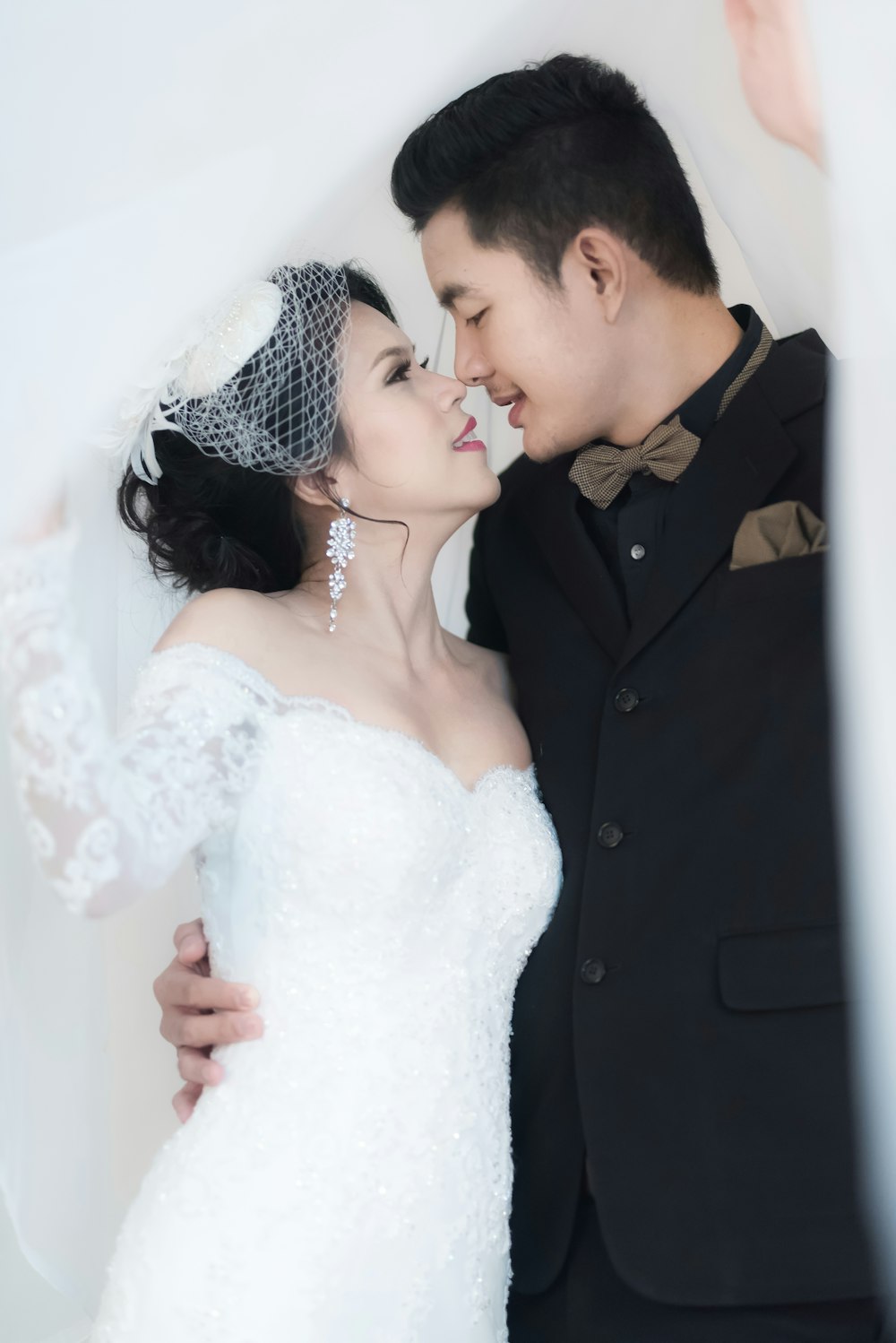 newly wed couple about to kiss inside room