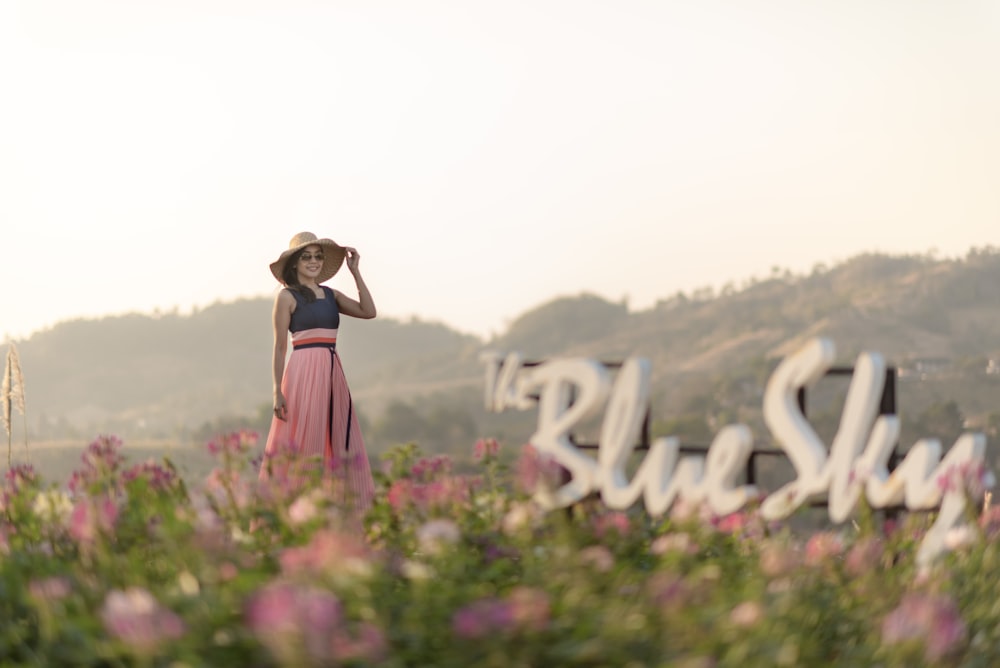 woman holding her floppy hat