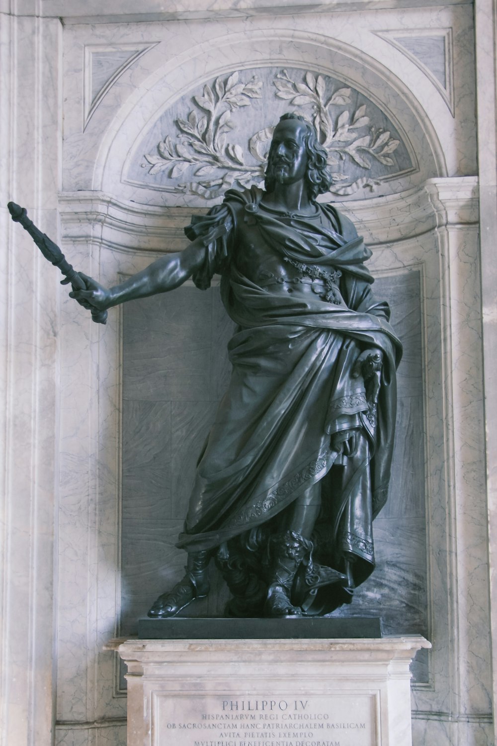 man holding scroll statue