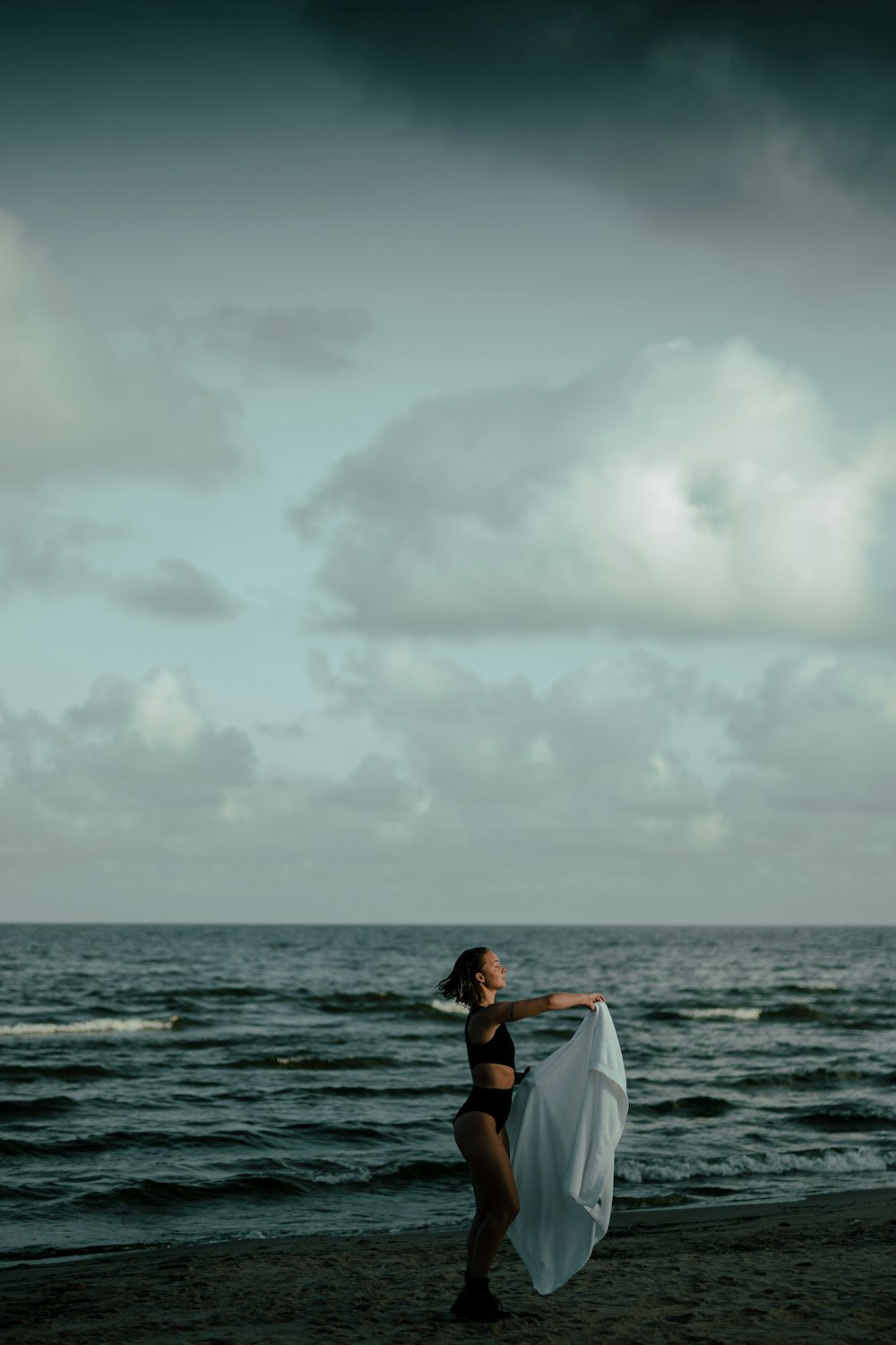 woman in two piece holding scarf