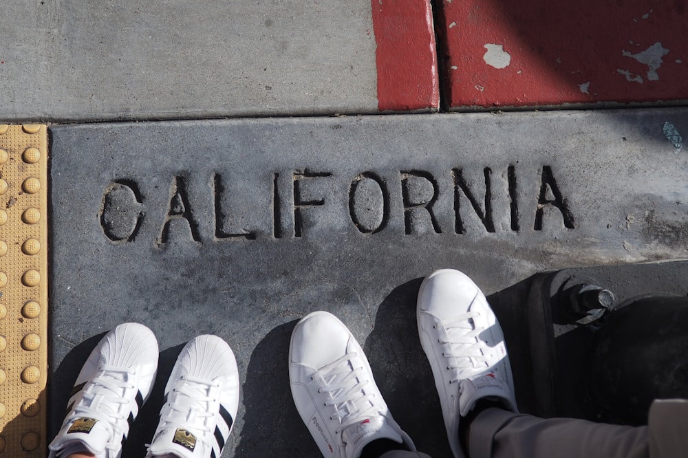 person wearing white sneakers