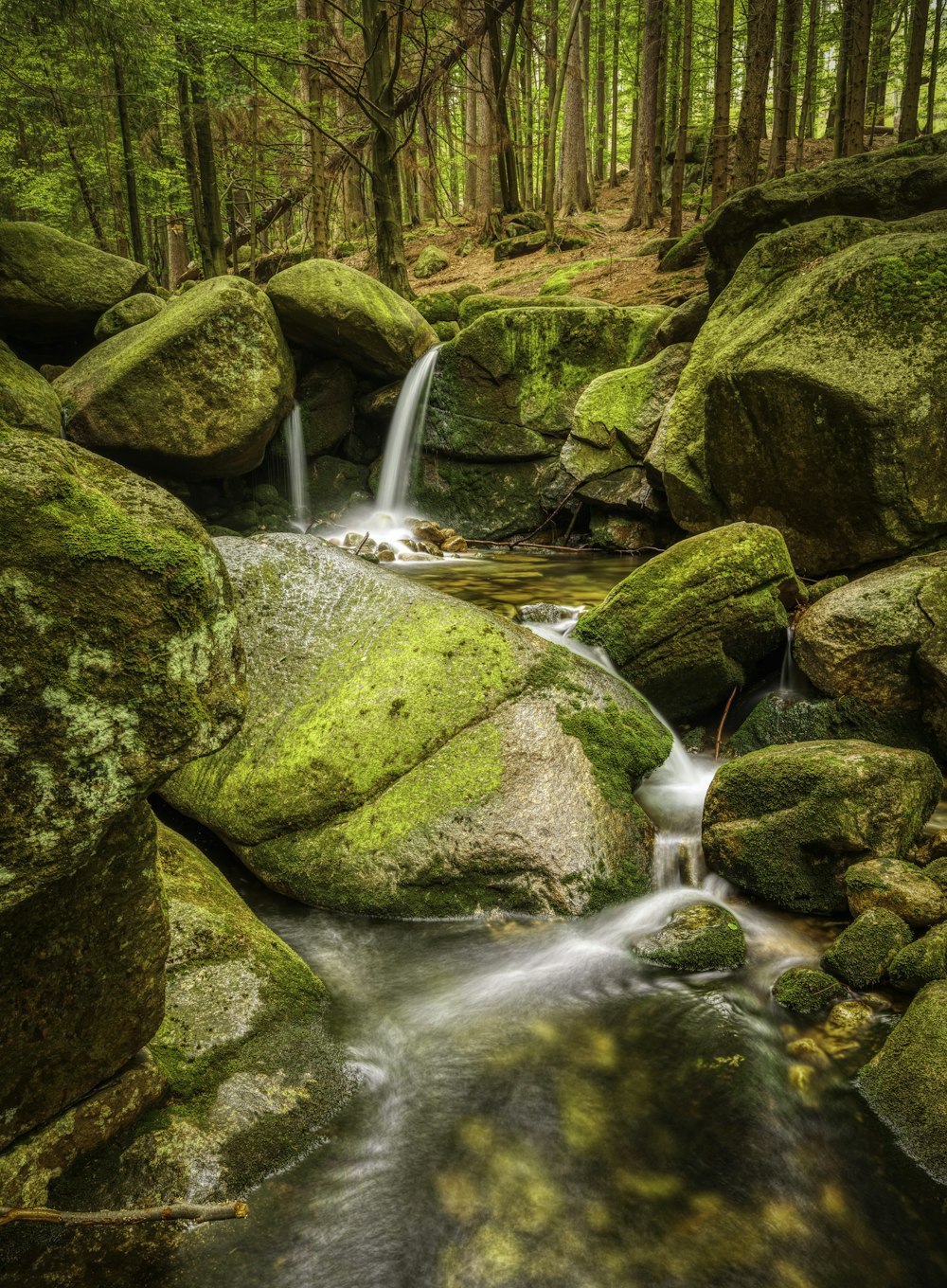 body of water flowing on rocks