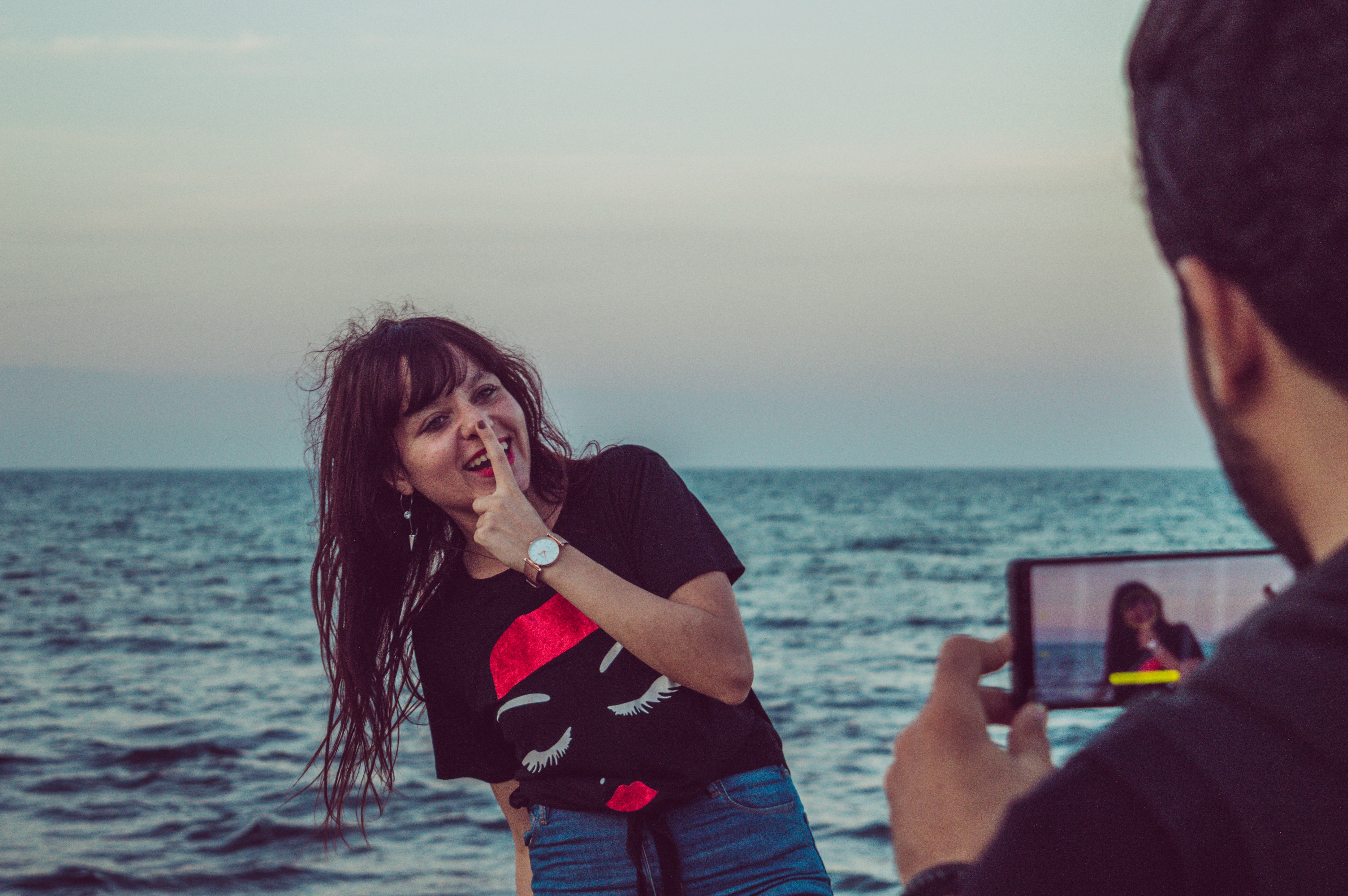 man taking photo of woman