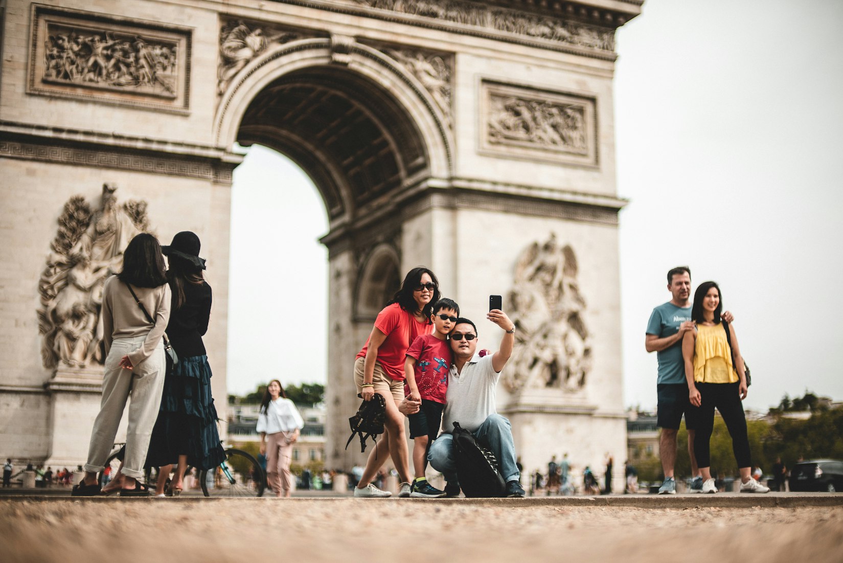 Tourists in front of the Arc de Triomphe in Paris, France (Mika Baumeister via Unsplash)