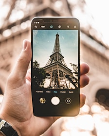 smartphone with Eiffel Tower during daytime photo