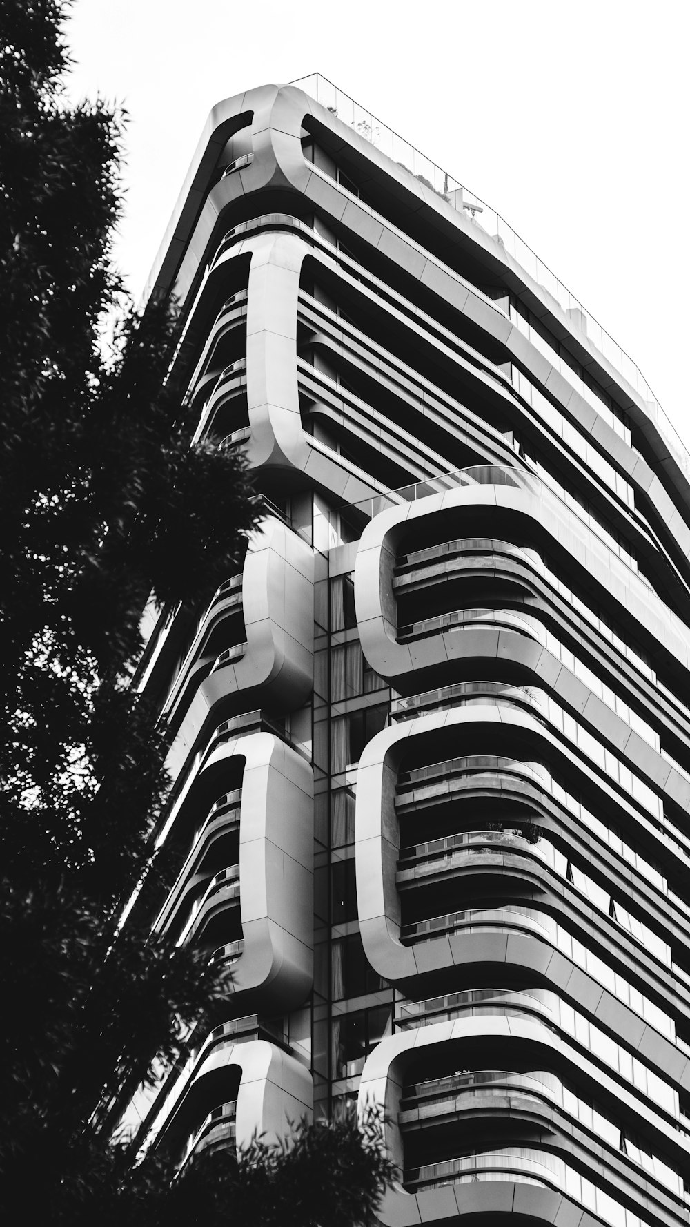 grayscale and low angle photography of concrete building