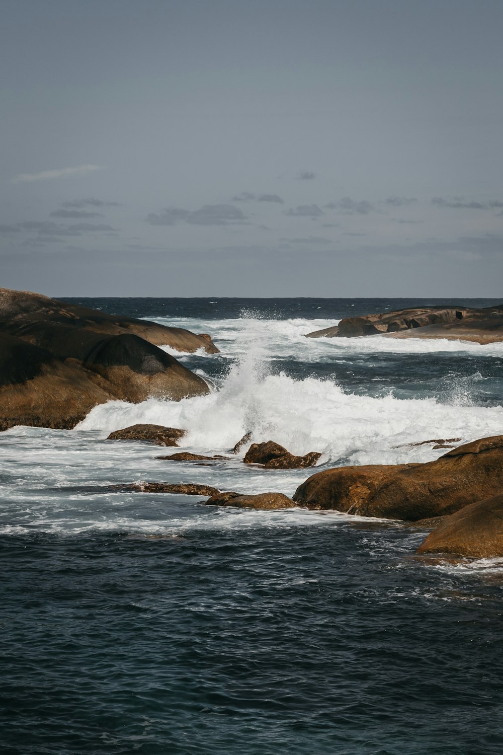 body of water near rocks