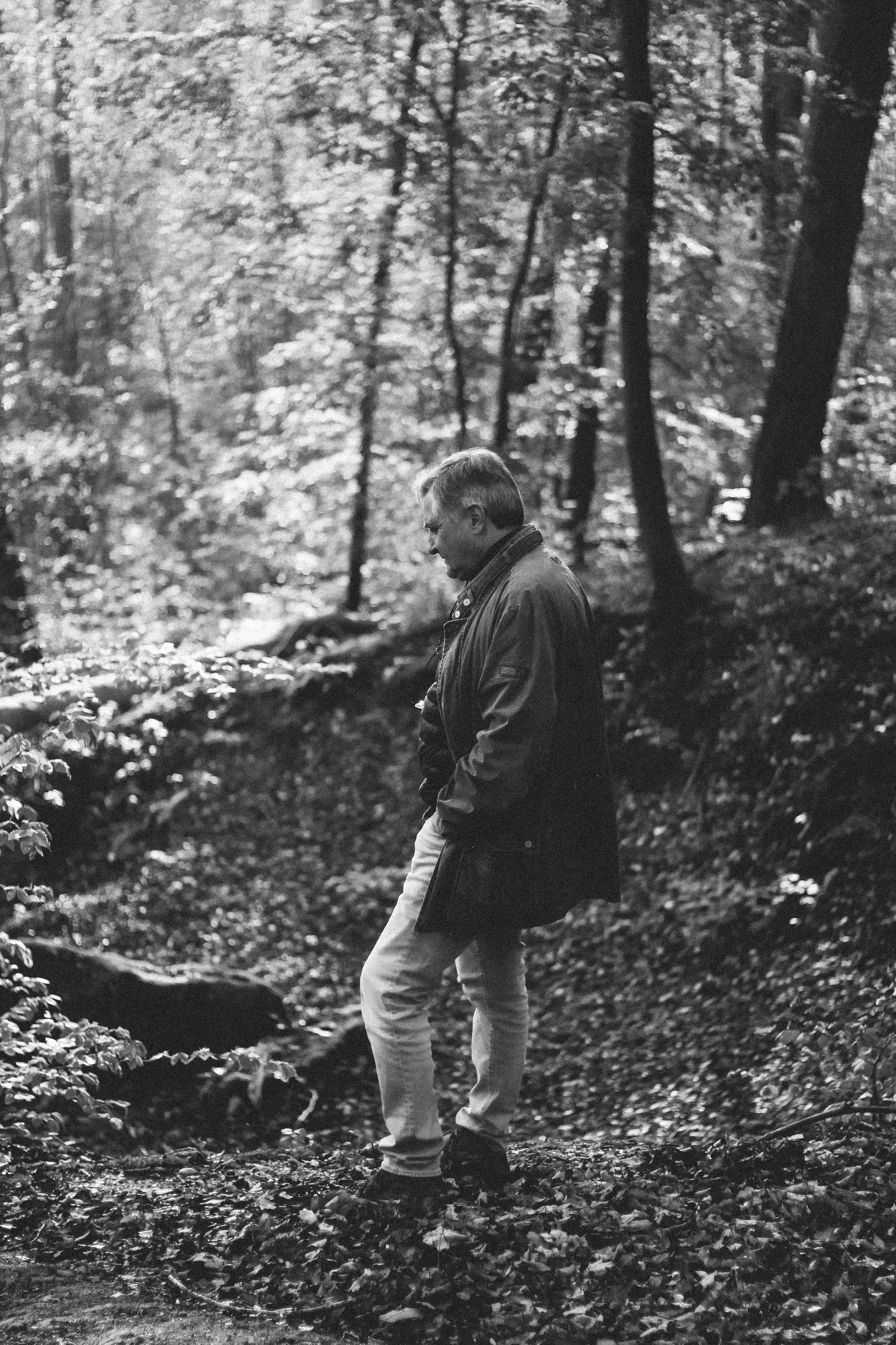 a man standing in the middle of a forest