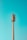 A tall communication tower with various antennas is set against a clear blue sky. The structure is metallic, with a ladder running up the side for maintenance purposes.