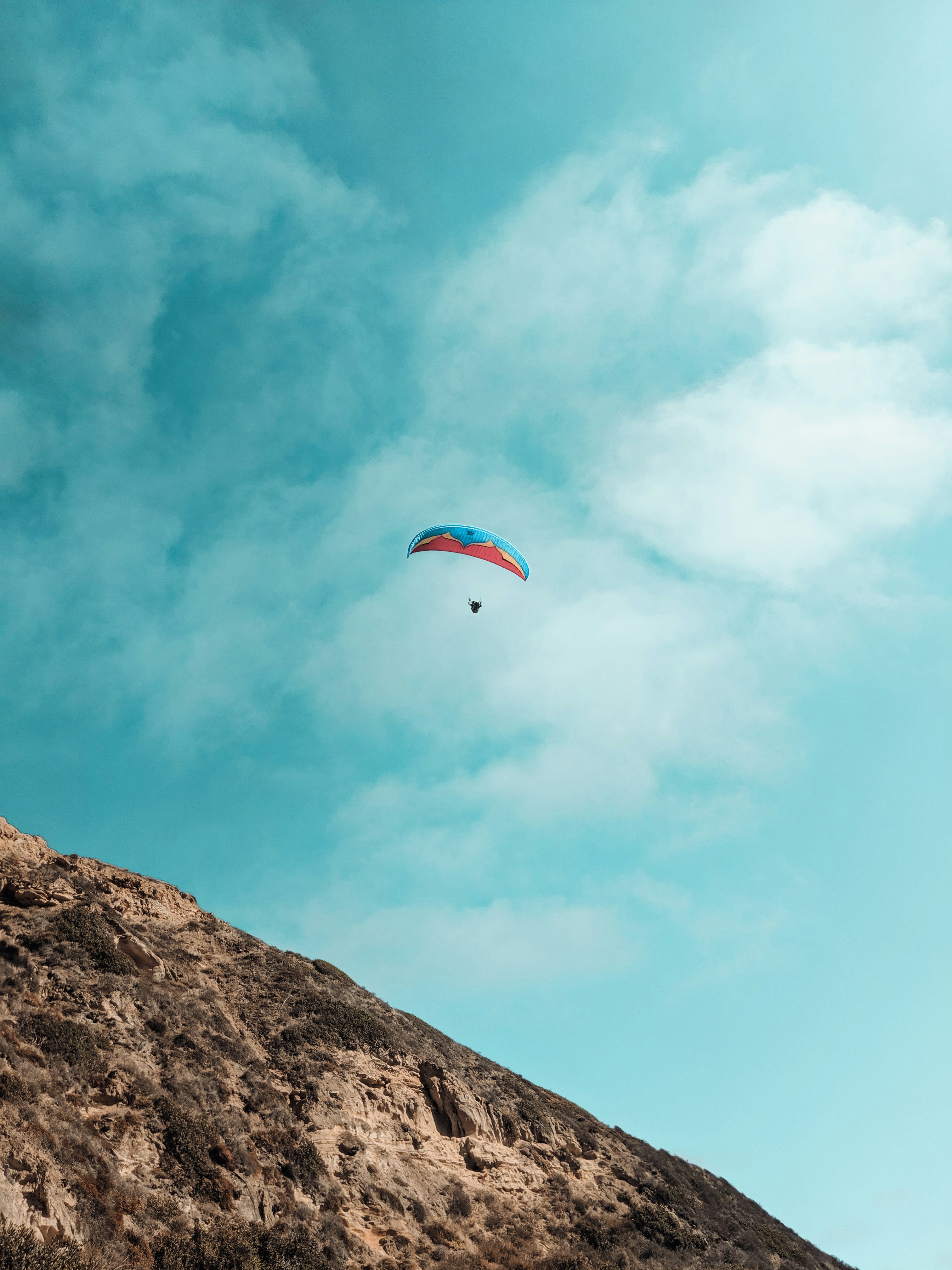 Person riding parachute photo – Free Sky background Image on Unsplash