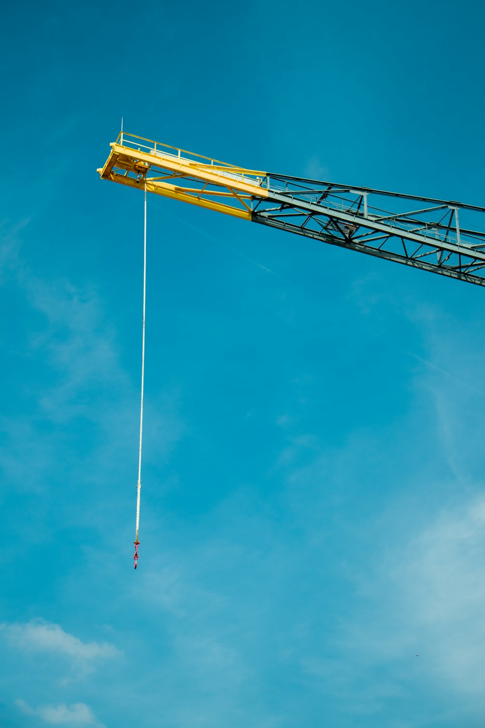 black and yellow tower crane during daytime