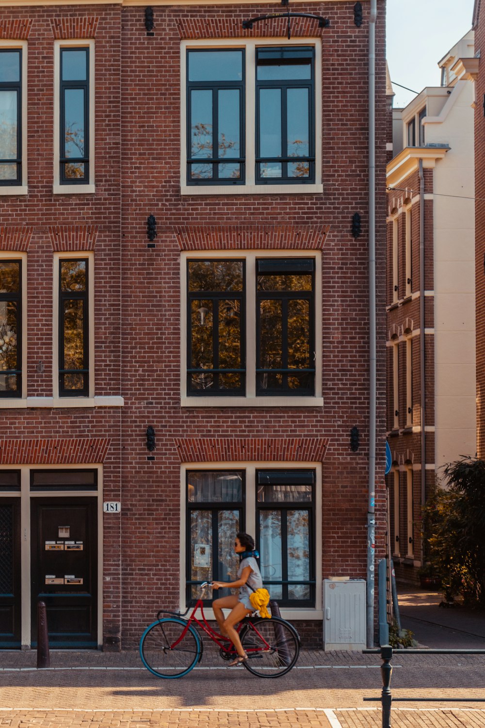 man riding bike in front of building during daytime