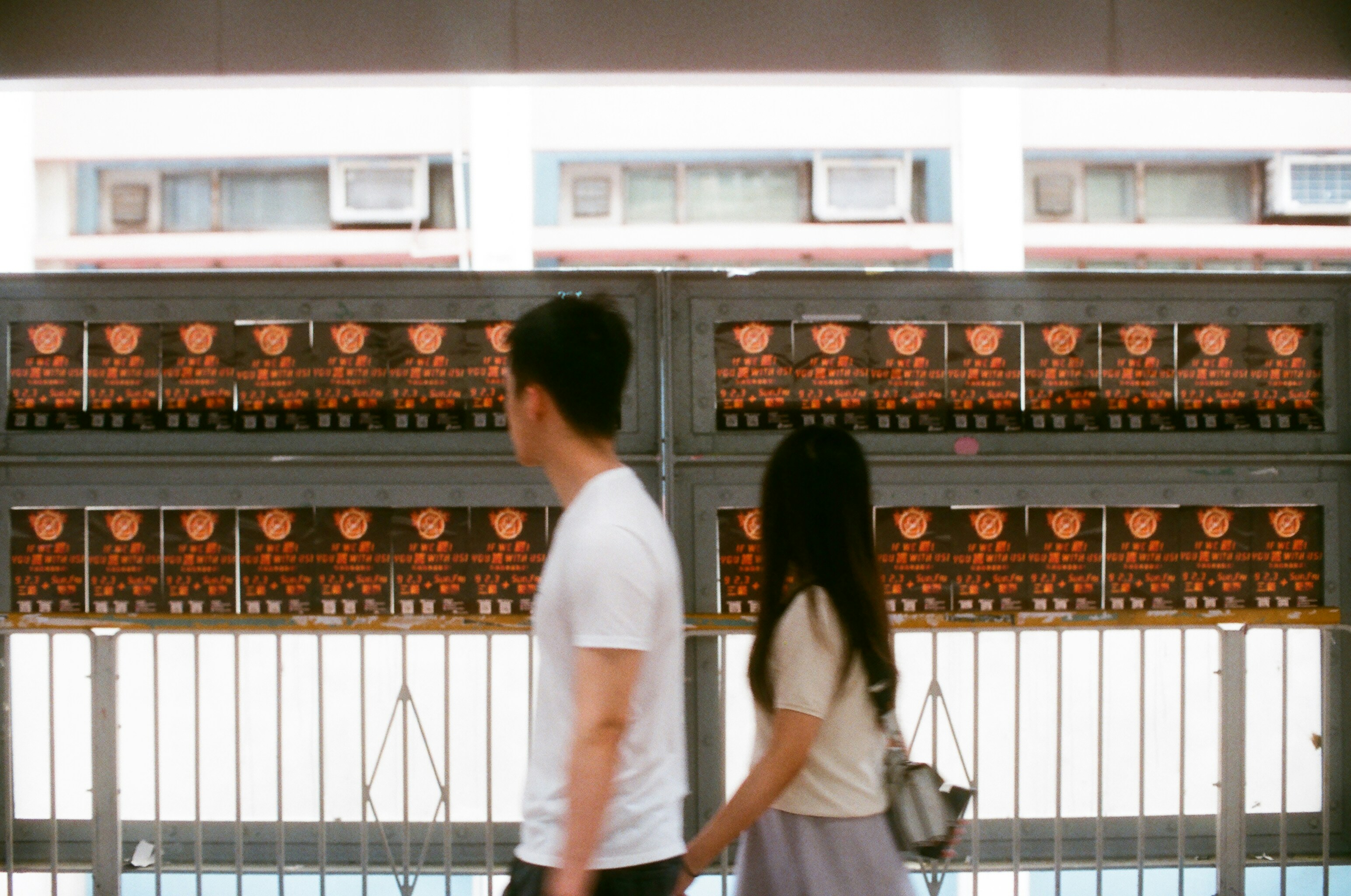 man and woman walking while holding hands