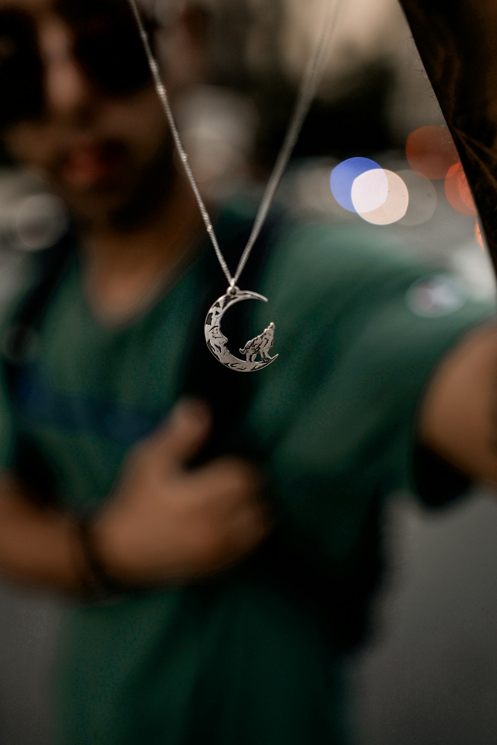 silver-colored half-moon pendant necklace