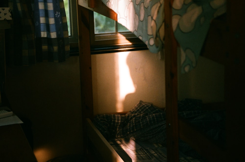 a bunk bed in a small room with a window