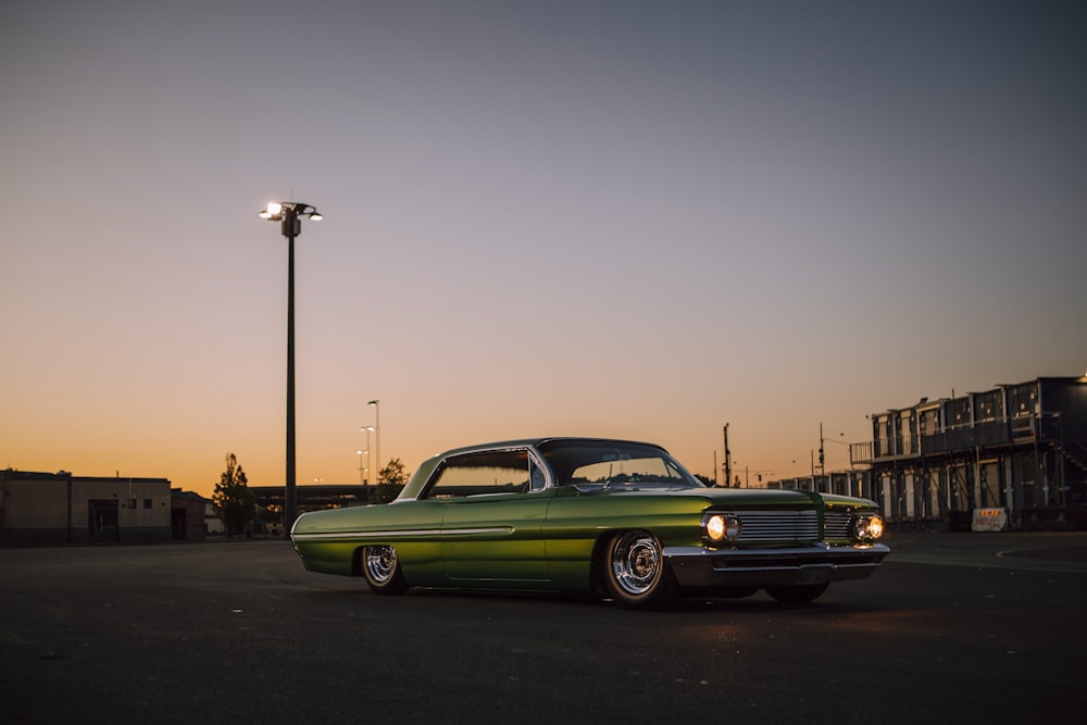 green coupe on road