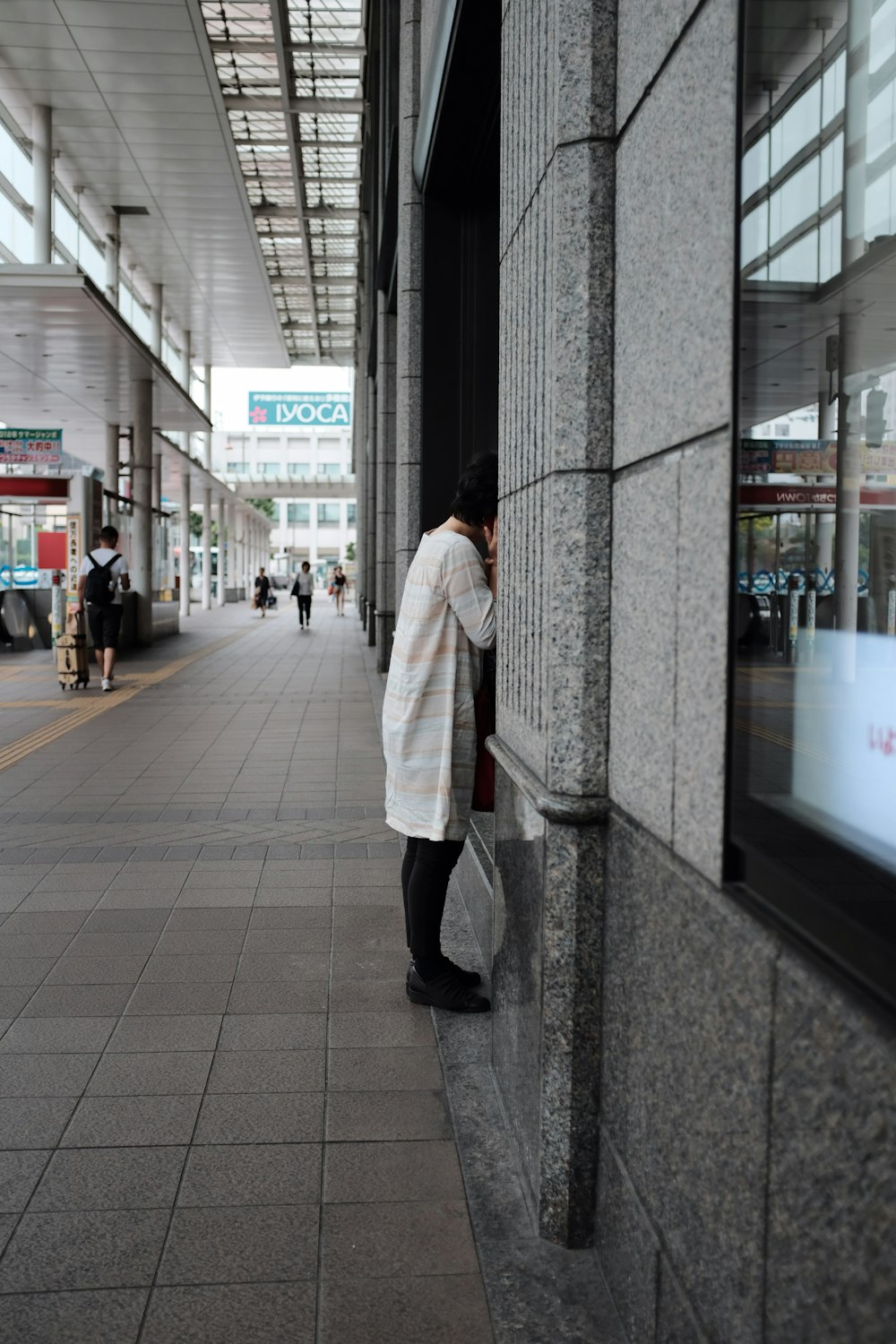 woman standing near building