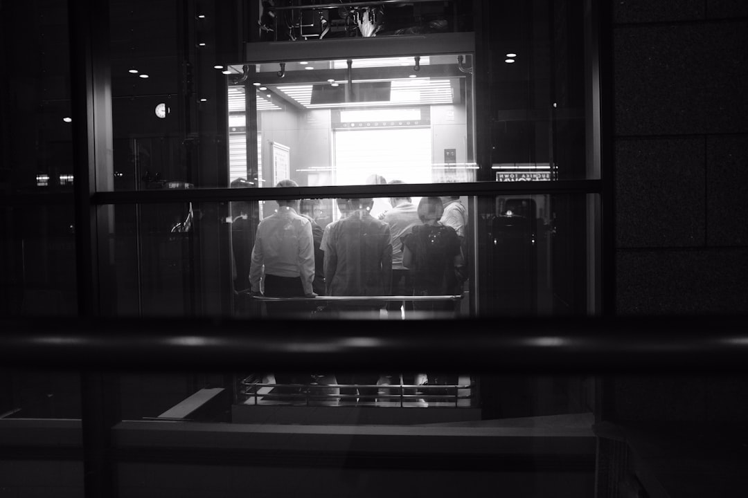 people inside elevator in monochrome photo