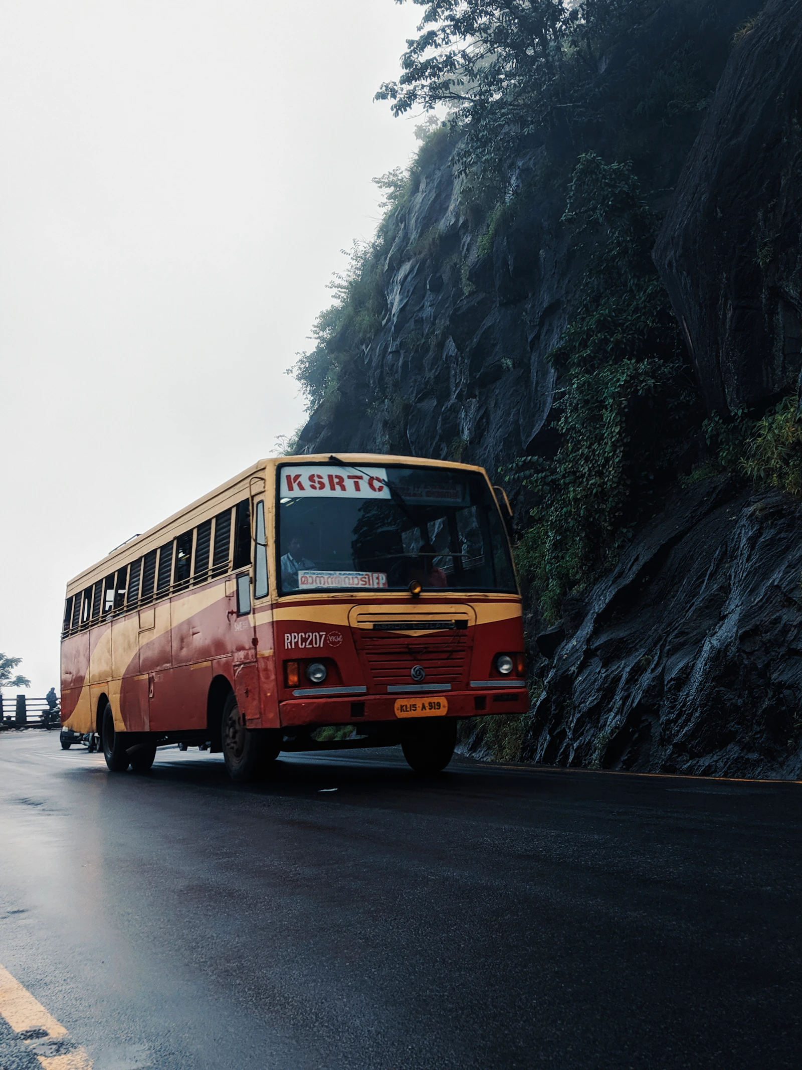 A Kerala state bus on a wet mountain road