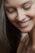 A serene image of a woman smiling, reflecting positive energy.