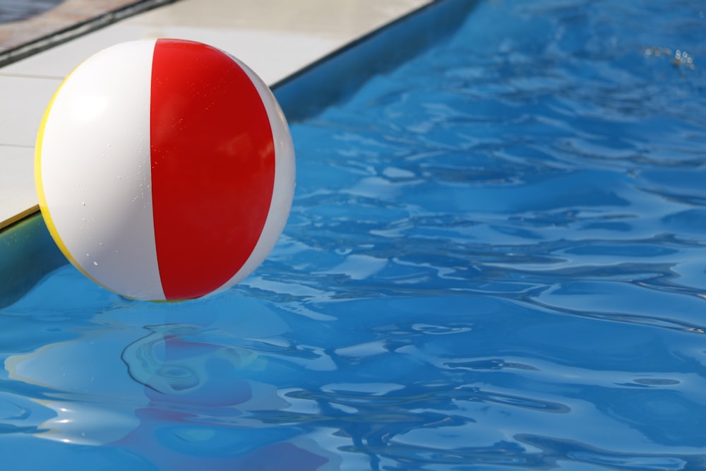 white and red balloon over body of water