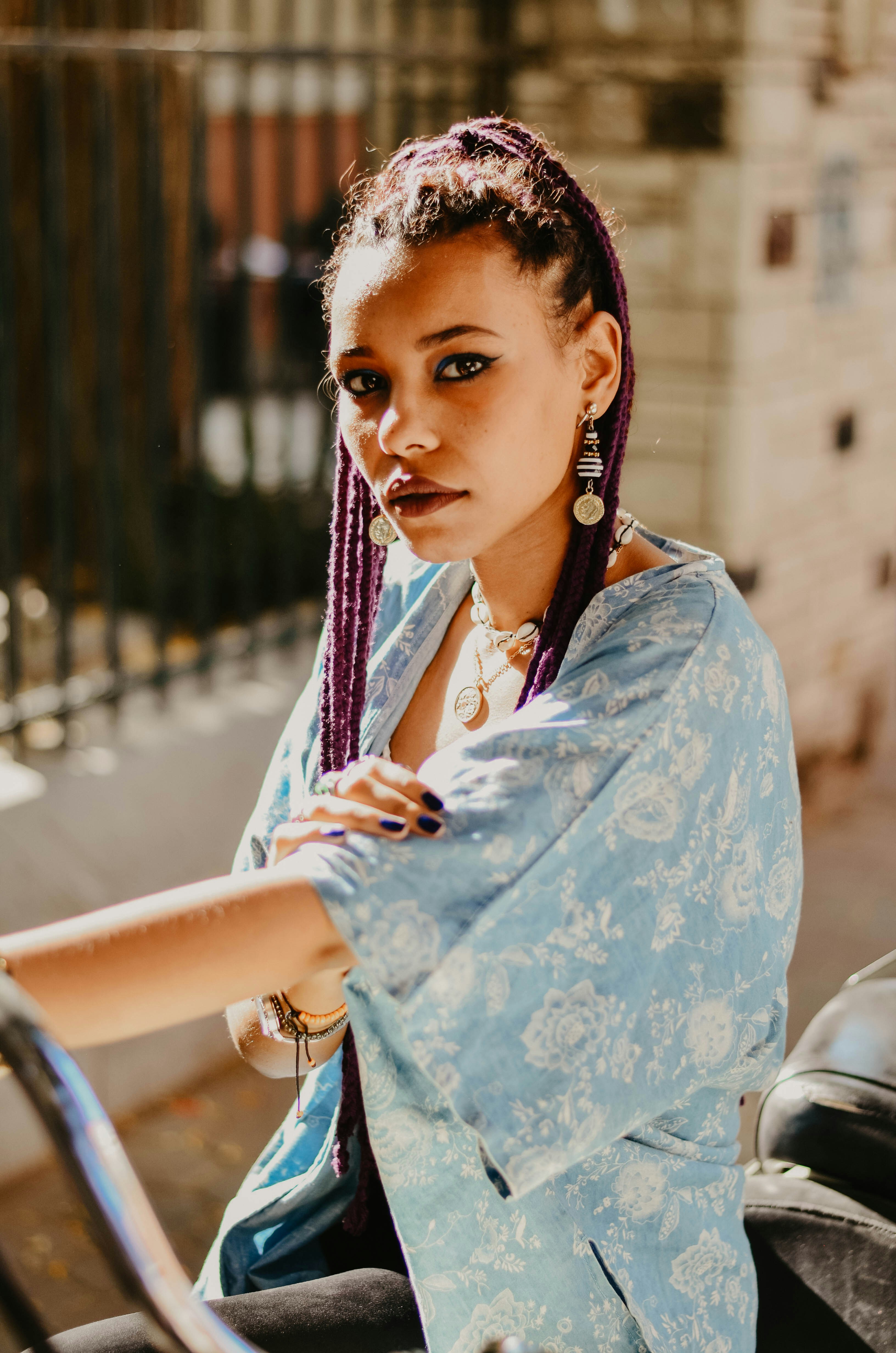 woman in blue and white top riding on motorcycle