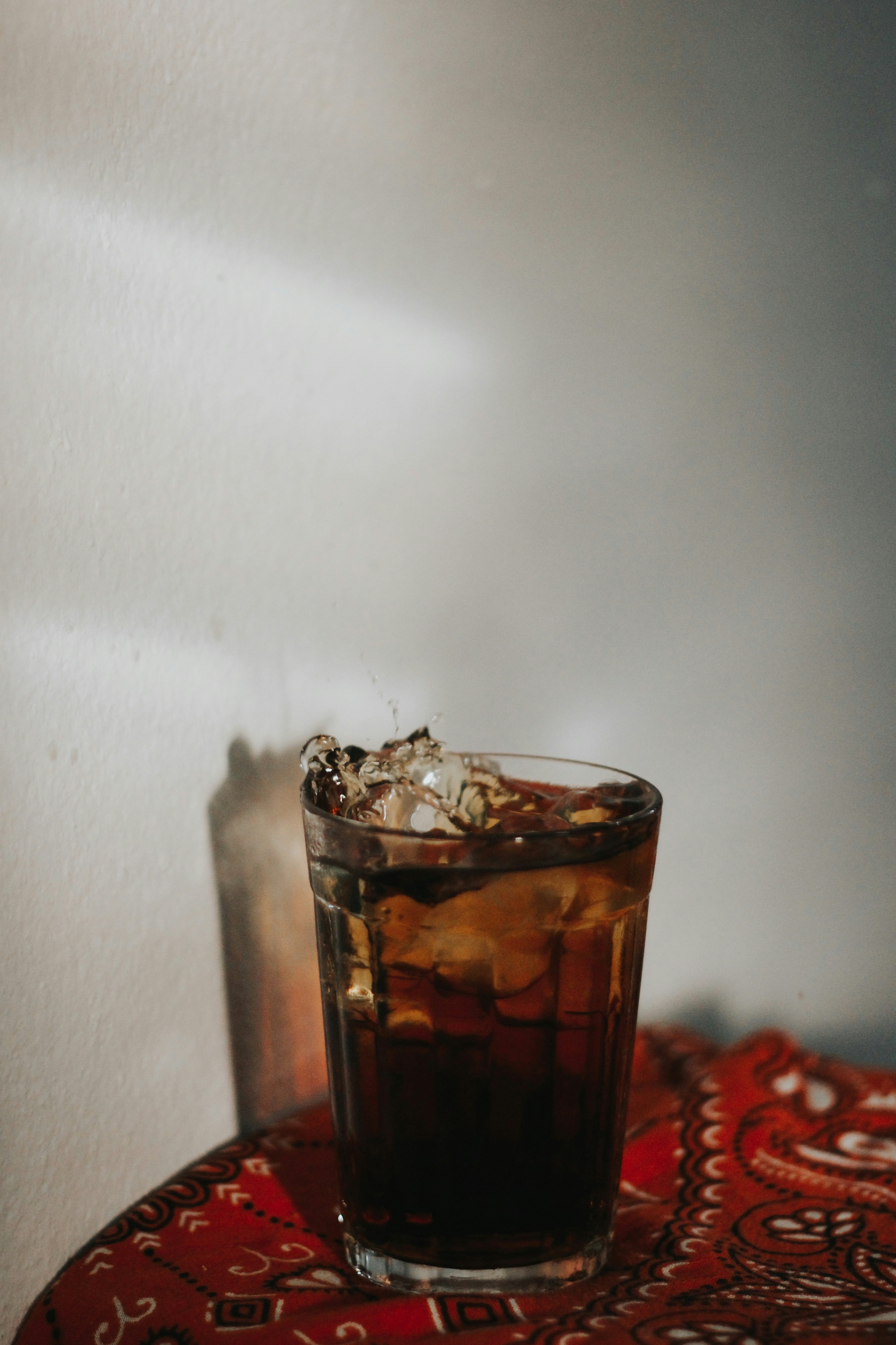 glass of carbonated drink on red bandana