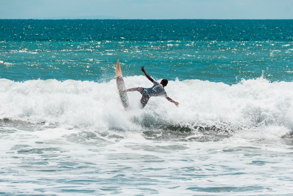 man riding surfboard