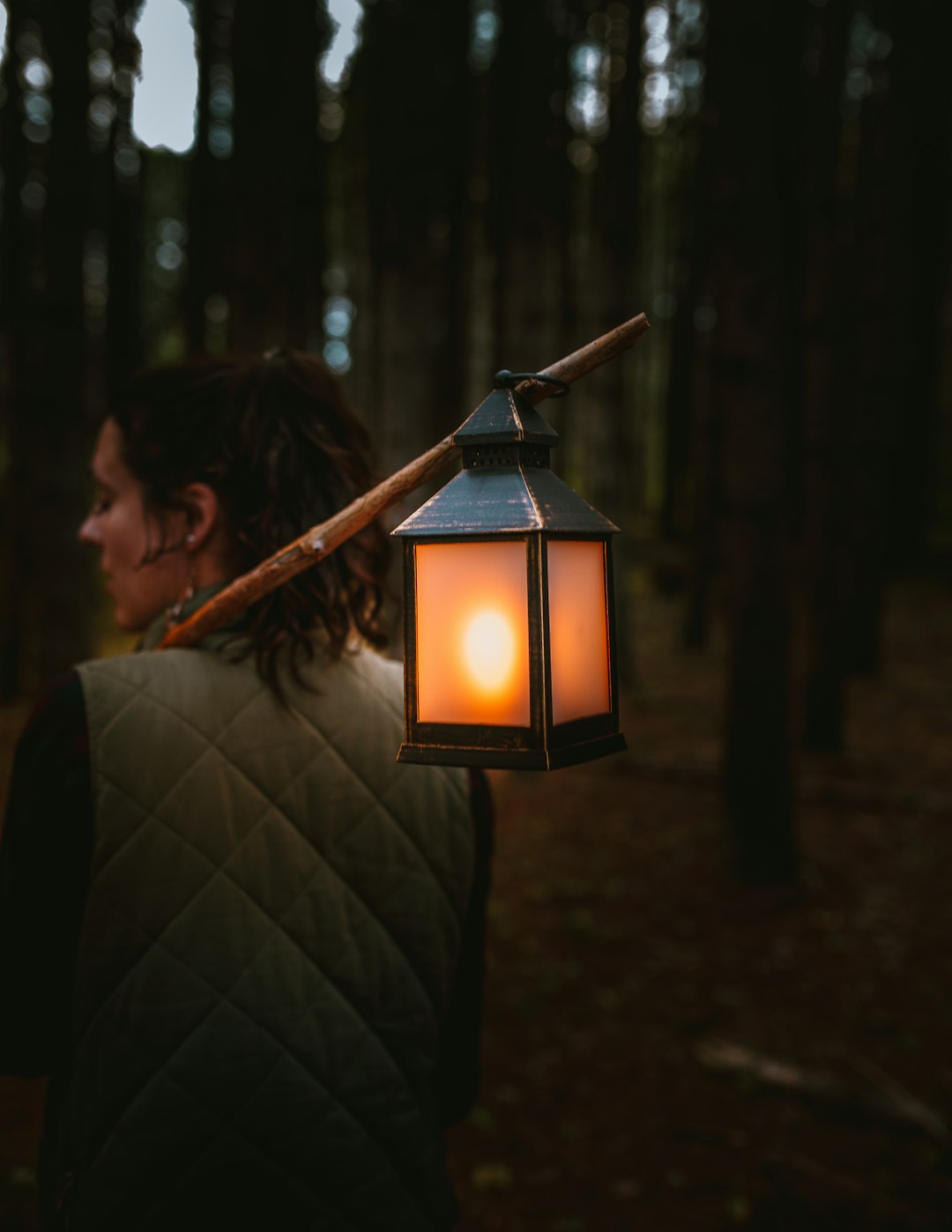woman holding candle lantern