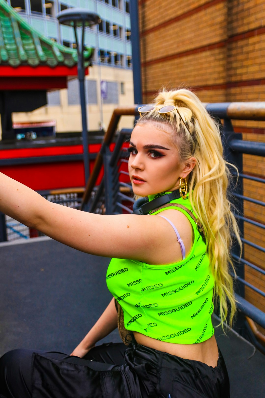 woman wearing green sleeveless crop top glancing her left side